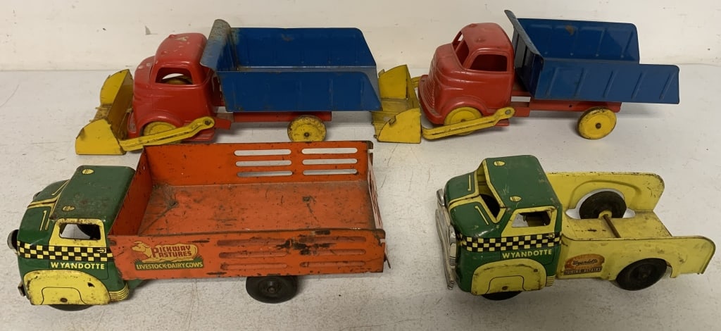 4 Wyandotte trucks: 2 have plastic cabs; have wear with scratches, paint loss, rust and one is missing pieces