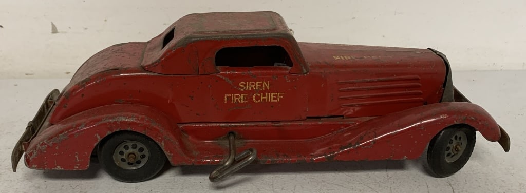 pressed steel Siren Fire Chief wind-up: has scratches, paint loss and rust; key wind does not function