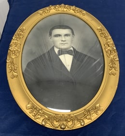 portrait in gilt frame with convex glass