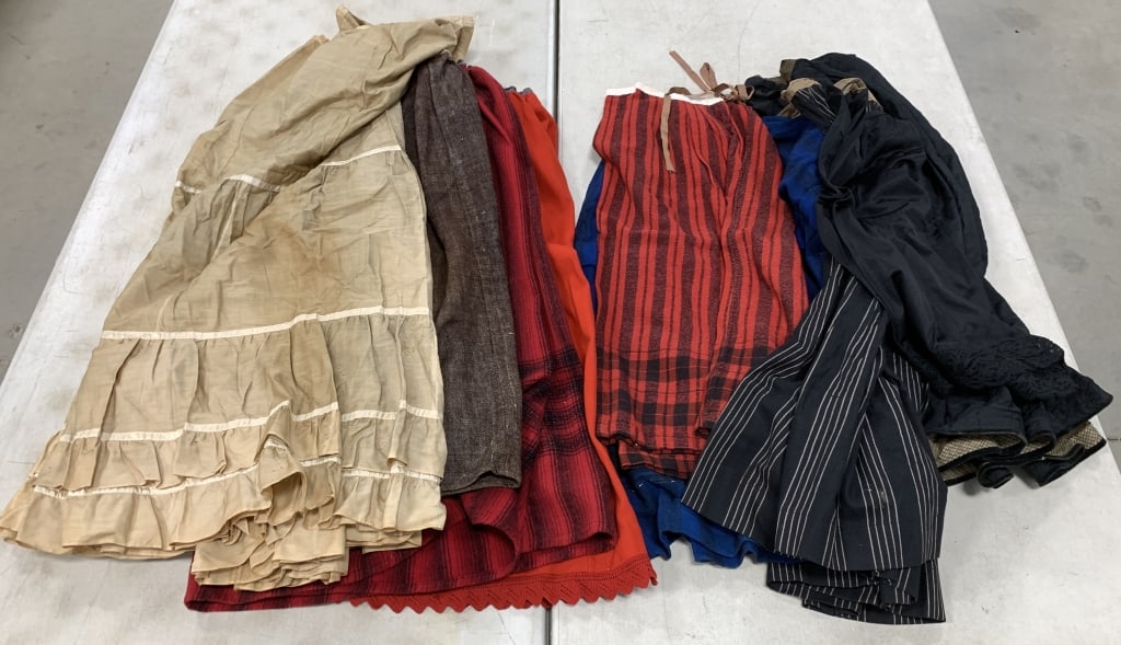 8 handmade skirts and a store bought slip: all have wear, staining and damage