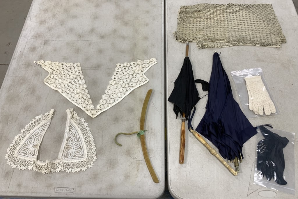 parasols, gloves, collars, scarf and hanger: parasol fabric is torn; other items have wear