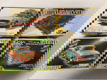 4 vintage car models in boxes