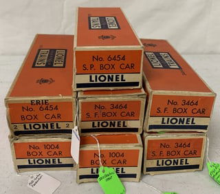 7 Lionel box cars in boxes