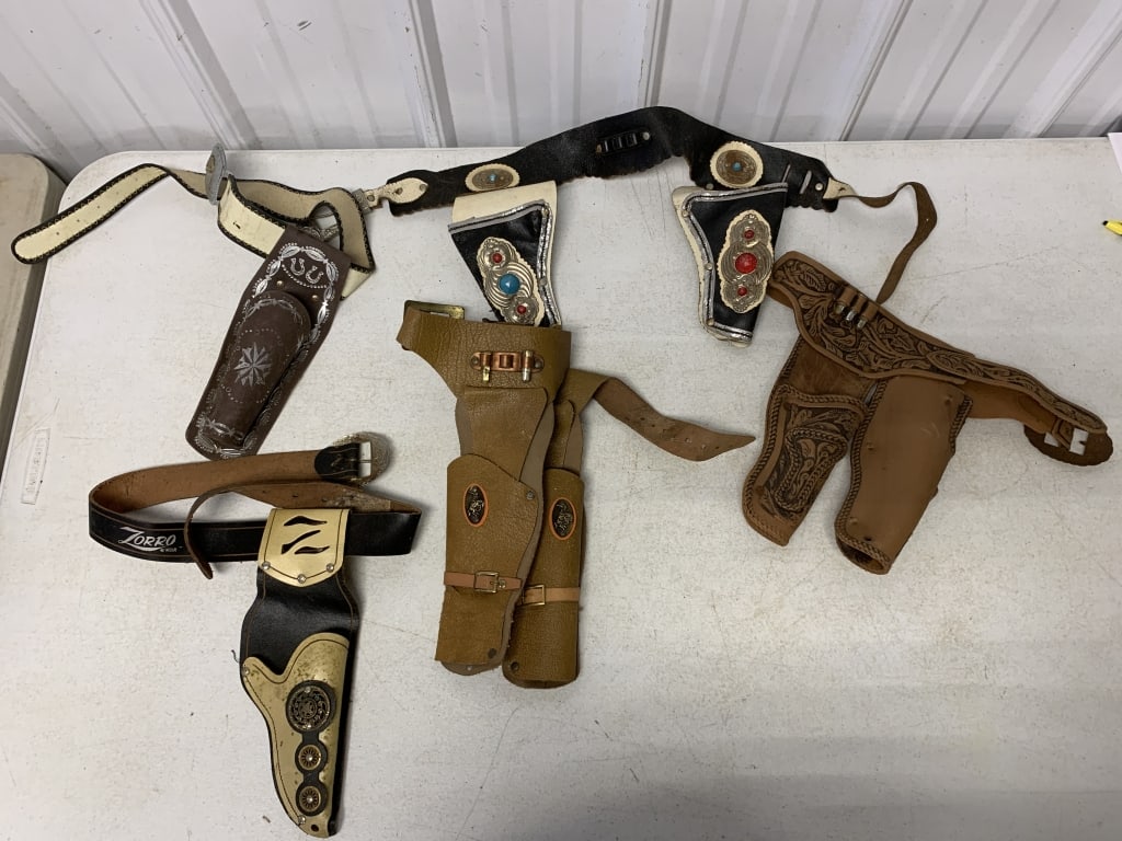 lot of cap gun belts and holsters, no cap guns: have wear with some damage as shown; some plastic, some leather