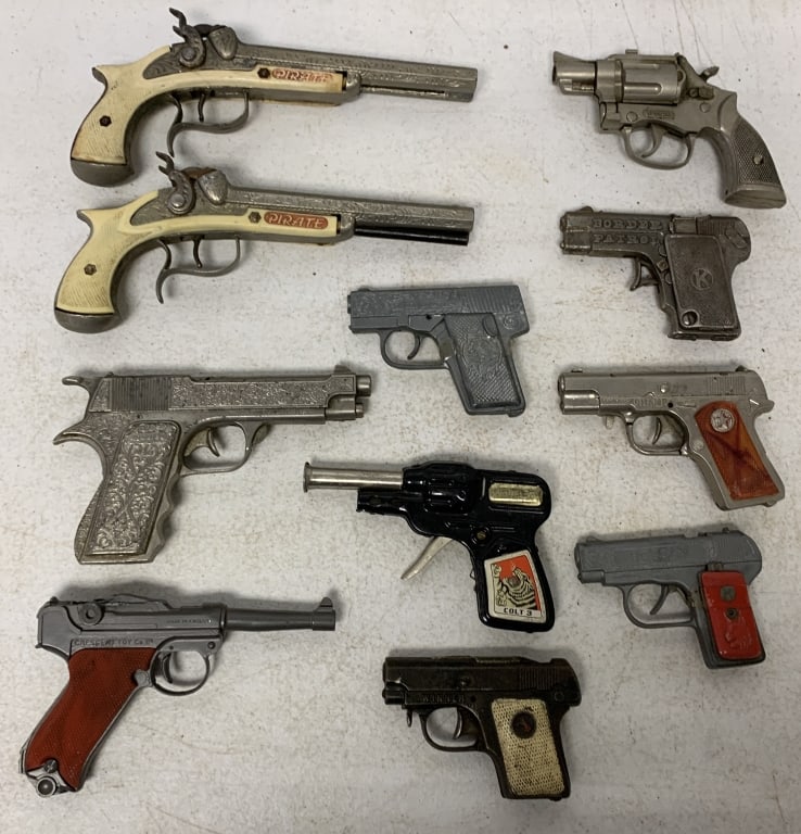 11 toy guns, not all working: all show wear as seen in photos; some damaged and missing parts