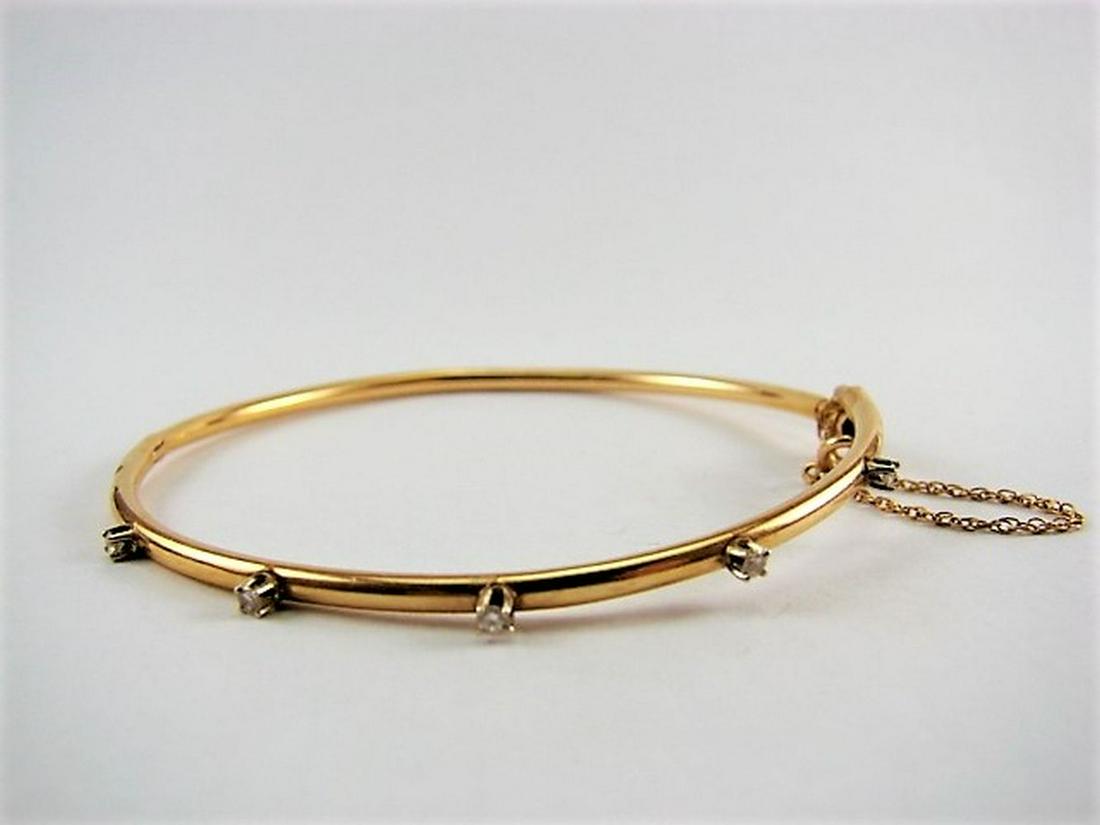 Vintage 14K Yellow Gold and Diamond Bangle Bracelet: Bangle bracelet with safety chain, five diamonds, weighs 3.5 grams