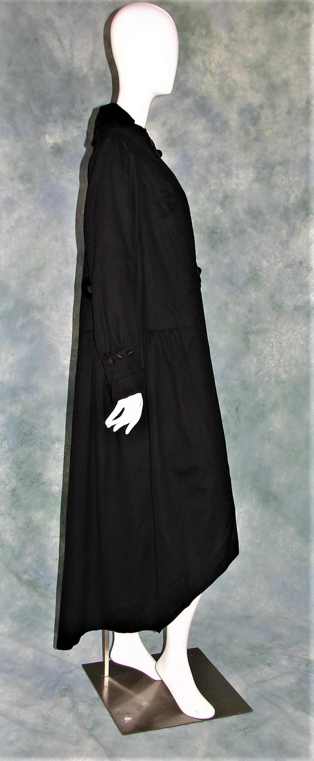 Edwardian Ladies Overcoat or Dress in a Black Wool: Beautiful ladies black overdress or coat with an open front panel, closes with 2 buttons on the left side, has black and grey circle embellishments at the waist and neck measures 54" in the back, 40" 