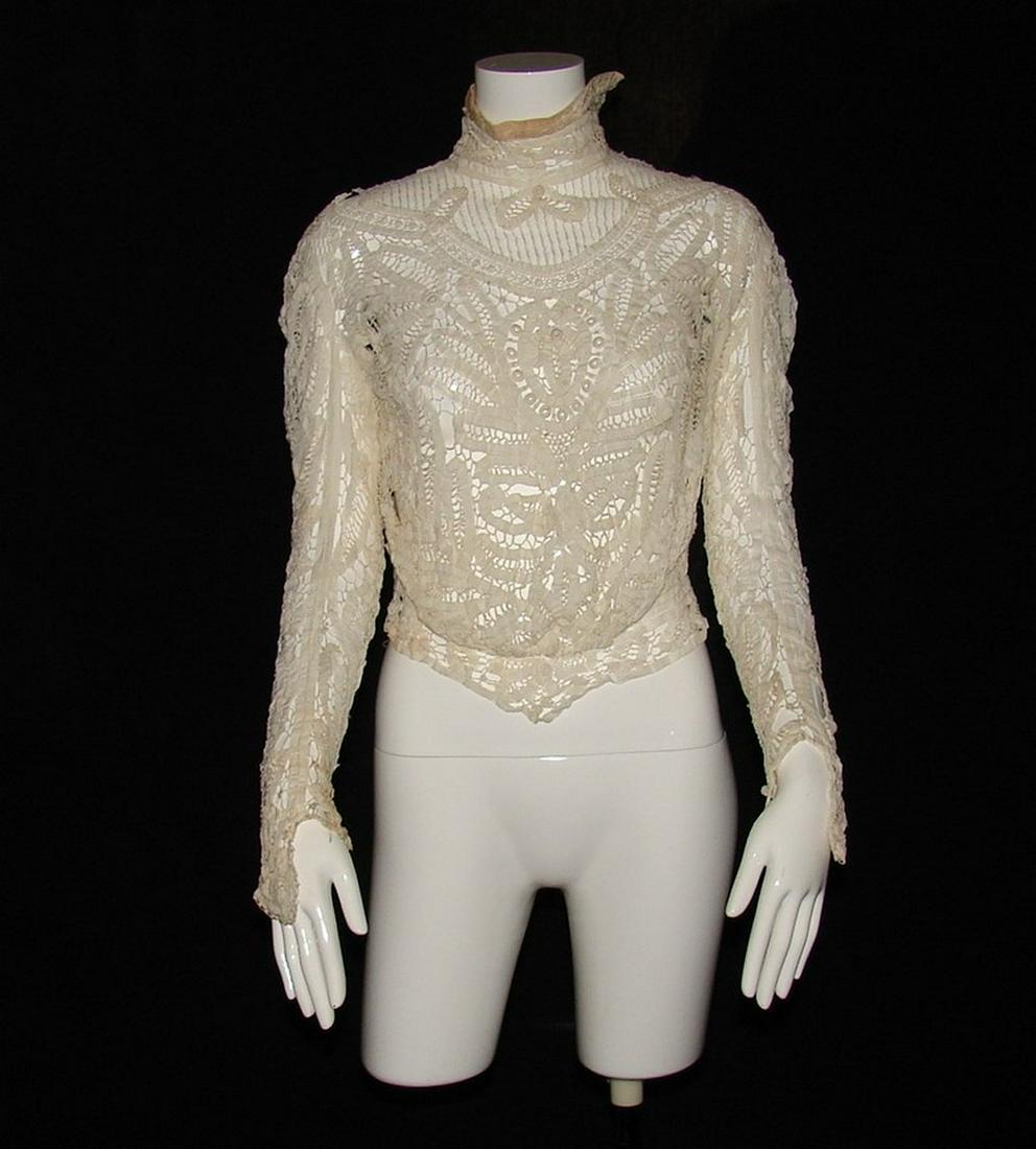 Edwardian White Mixed Lace Blouse, Circa 1907: mixed laces, closes in back, - no buttonholes or hook and eyes, velvet detail at collar, 22"L x 30"B x 20"W. Provenance: Edith Lotterhos Estate, Crystal Springs, MS, as part of her European Grand Tour