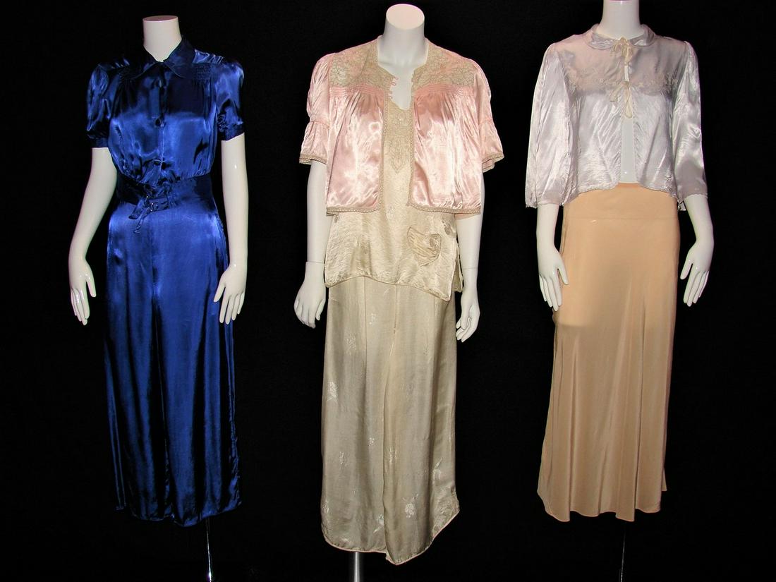 7 Ladies 1930s Silk Lingerie Pieces: one long silk skirt, one cream lounging pajama pants, one blue lounging pajama set, one cream silk ladies camisole with embroidery, two peach bed jackets, one in silk with lace and one blue. Ladies bl