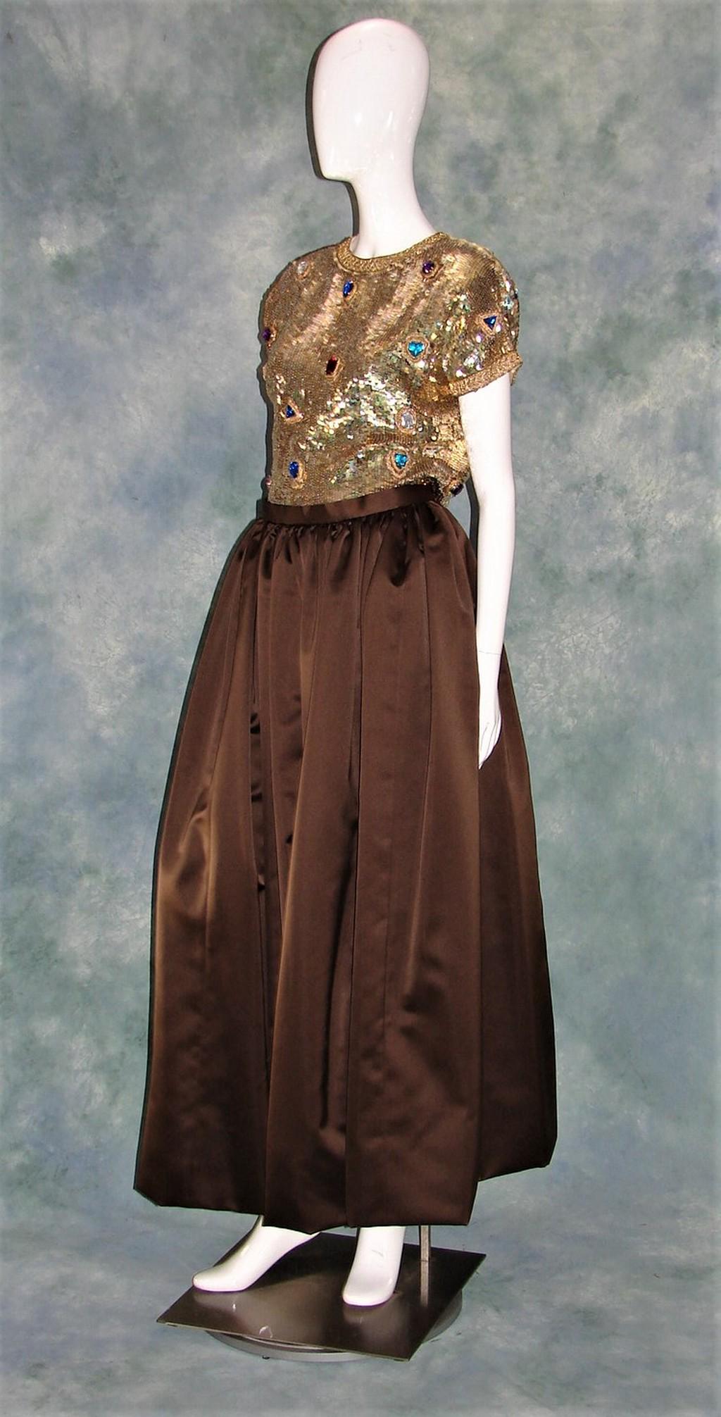 Vintage Oscar De La Renta Studio Evening Dress: For Montaldos, marked a size 10, bodice is covered with gold sequins and bejeweled with multi-color stones, silk waist and satin skirt, lined, measures 45"L X 40"B X 36"W X 36"H, closes with back zipp