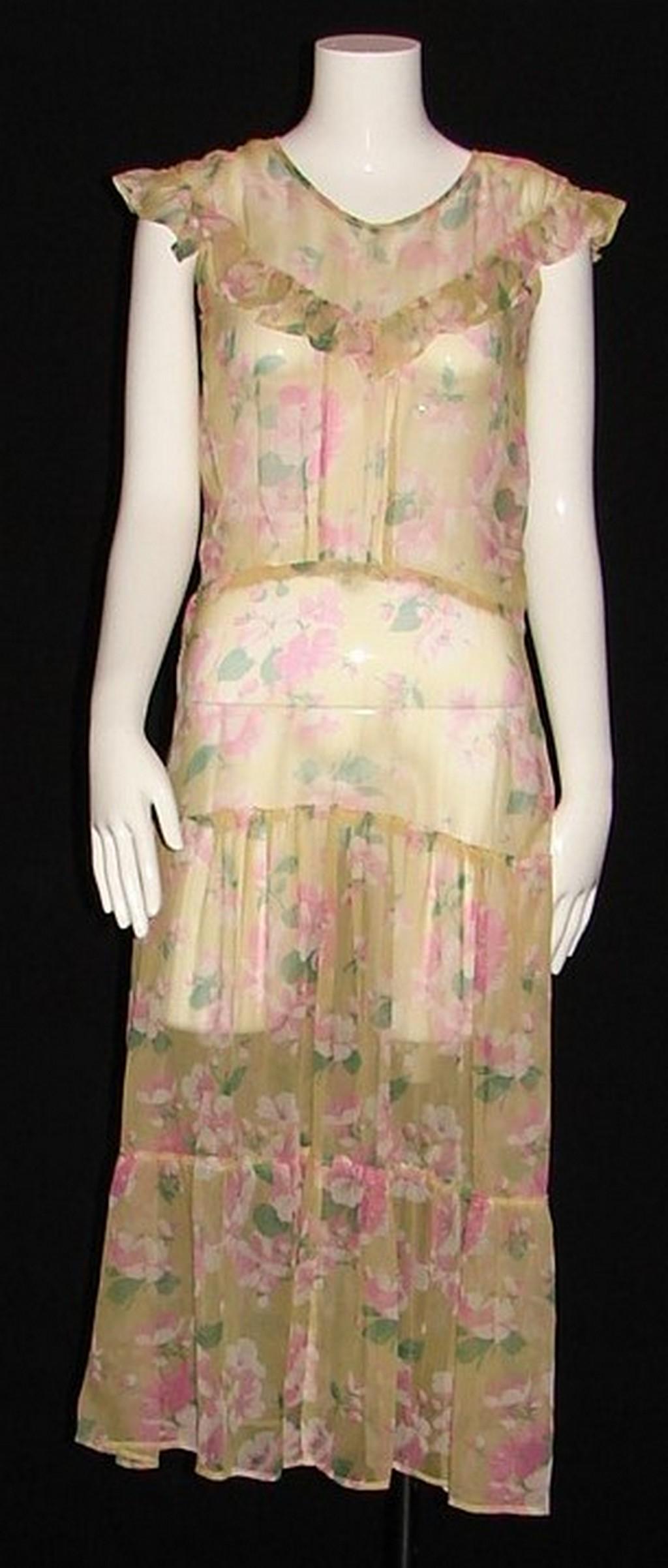 1930s Yellow Silk Chiffon Gown with Allover Pink and: ruffle at the collar, empire waist with wide panel over hips leading to gathered skirt and additional applied gathered flounce, 48"L X 36"B X 30"W X 34"H, closes on side with metal snaps