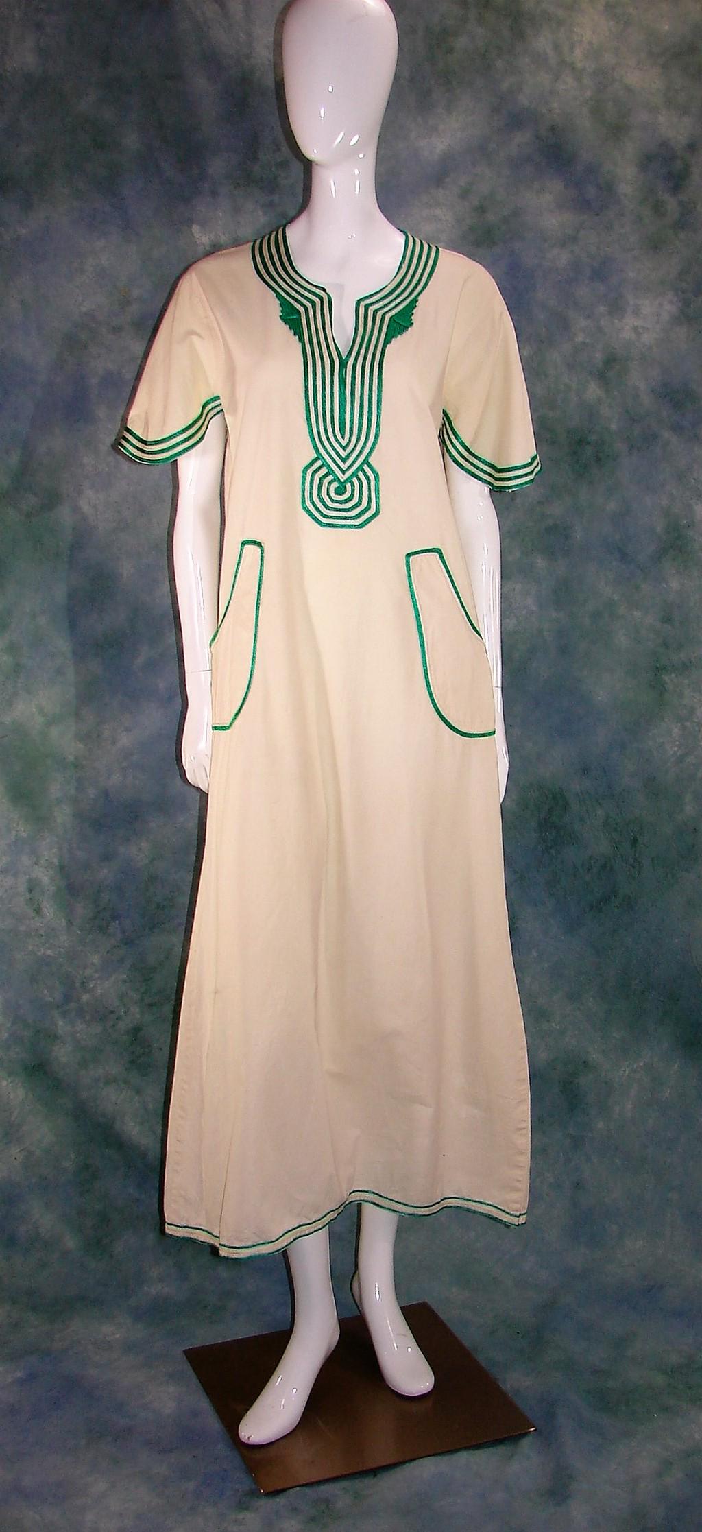 Ladies 1960 White Caftan with Green Trim: Measures 52" long, 40" bust, 40" waist, 17" shoulder to shoulder. Has two large pockets in the front.