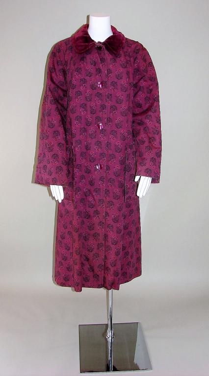 Ladies 1950s Long Coat: Has a maroon background with all over floral sprays and a velvet collar, fully lined, 2 large pockets, closes with 4 buttons, well made, 49" L x 16" shoulder to shoulder x 44" B x 52" W