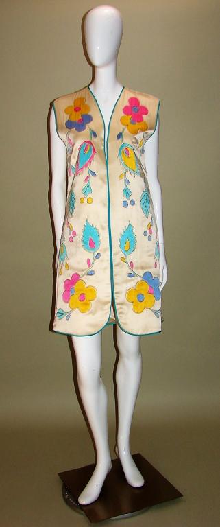 Michael Hrnjak For Neiman Marcus Vest: Padded gold silk vest with turquoise silk piping, hand painted floral design all over that looks like watercolors, design has been outlined in gold thread 38" L x 38" B x 38" W