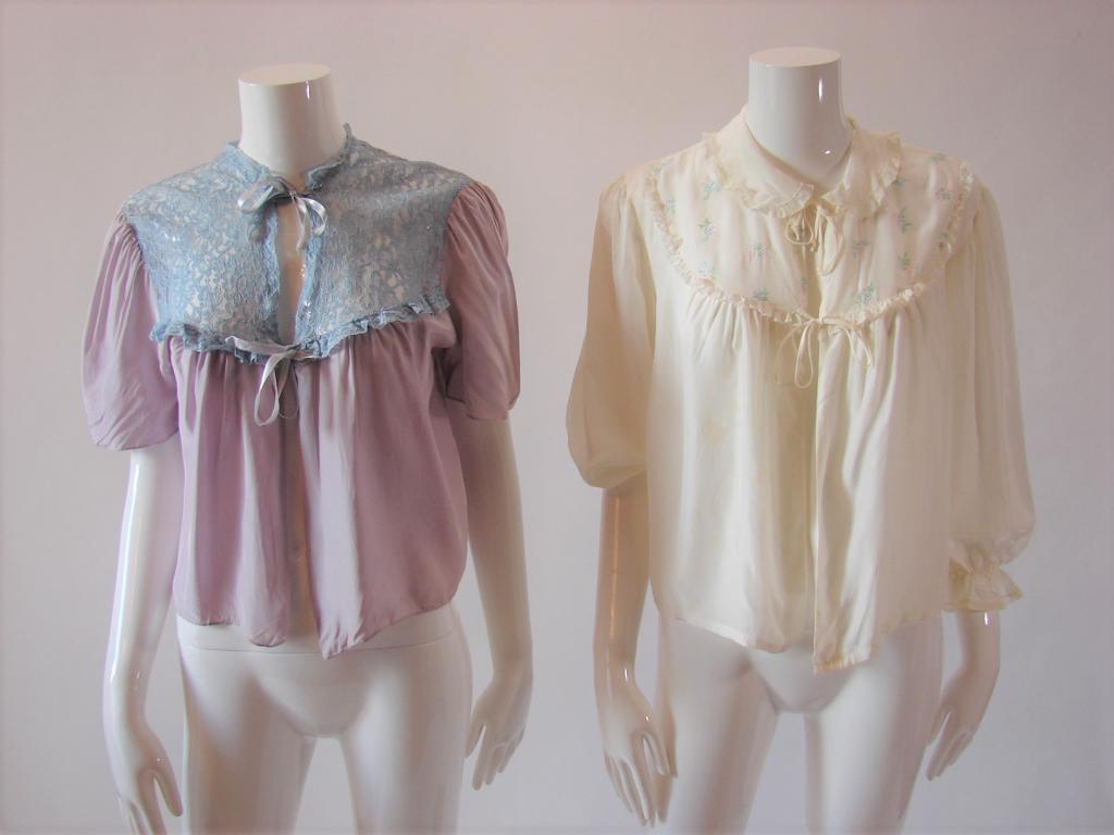 2 Vintage Lingerie Bed Jackets: Both feel like rayon 1) Lavender with blue lace and blue silk ribbons 20" L x 40" B; 2) White by Eastern Isles (marked Large) with embroidery on the yoke, applied lace 22" L x 44" B