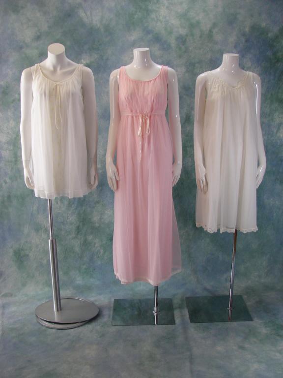 3 Vintage Nightgown and Robe Lingerie Sets: 1) Long pink set by Miss Elaine, robe 52" L x 36" B x 40" W; gown has a drawstring at the waist 52" L x 38" B x 38" W 2) Baby doll set by Shadowline in white marked small, robe closes with 2 buttons a