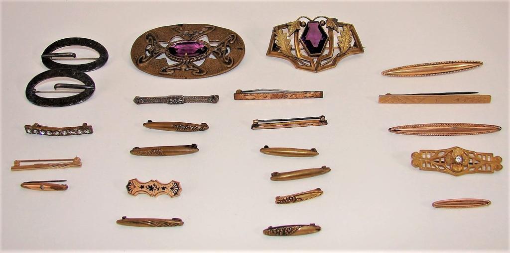 Edwardian Costume Jewelry Lot Sash and Bar Pins: 1) 2 Art Nouveau sash pins with amethyst glass centers2) pair of sterling silver sash pins3) sterling bar pin with filigree4) 3" gold bar pin marked CT5) 3" monogram and etched bar pin marked S & C6) 