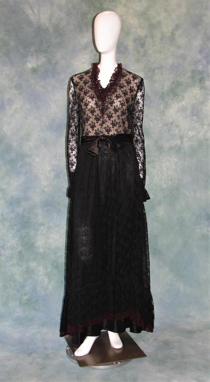 1970s Black Romantic Maxi Dress: All over lace, long sleeves, asymmetrical hem, zips up the back, self belt, has a ruffle hem, collar, and wrists, closes with a zipper and a hook and eye, metal snaps in the back 59" L x 36" B x 28" W
