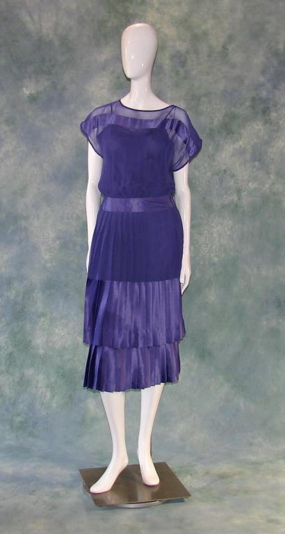 Vintage Tone on Tone Purple Chiffon Dress: 1990s, comes with original underdress, sleeves have been taken in on one side of the underdress. Dress is purple chiffon blocked with purple silk satin ribbon, 2 rows of knife pleats on the skirt, und
