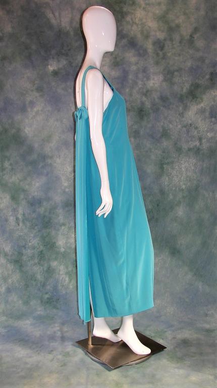 Vintage Oleg Cassini Black Tie Dress: Long turquoise gown that is fully lined, jersey like fabric, self scarf panel in the back is attached by 2 bow embellishments, closes on the left side with a zipper and hook and eye 52" L x 38" B x 36