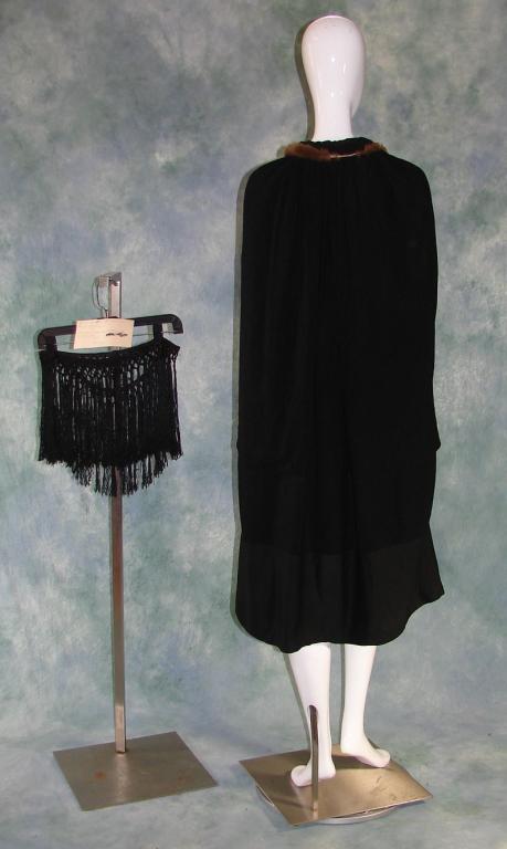 Black Crepe Cape c.1923 w/Fur: Black silk crepe, lined with green silk, knotted fringe (once attached, 61" L x 10" W) is included Cape is 44"L .