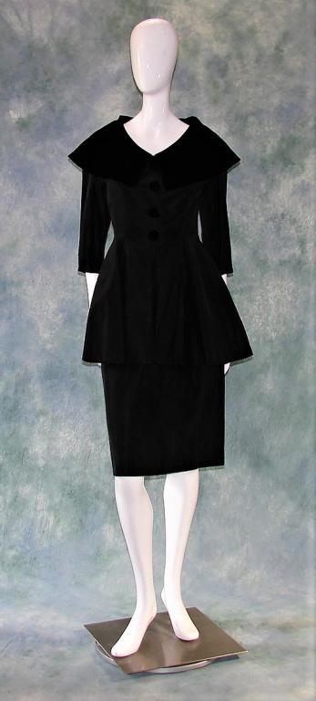 Black Taffeta Dress and Jacket: 1950s Black taffeta dress with metal zipper on the side, piping at the neck, pleats and darts throughout. 3/4 length peplum jacket, velvet collar, 4 large velvet covered buttons. Jacket: 30" L x 34" B