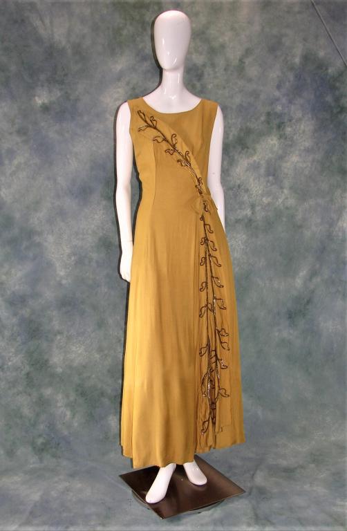 Mike Bent Gold Floor Maxi Dress: Heavy gold cotton gown with sequin detail and bow at waist, gold tulle petticoat, metal zipper in back, 57"L X 38"B X 32"W X 40"H. Stunning gown in person