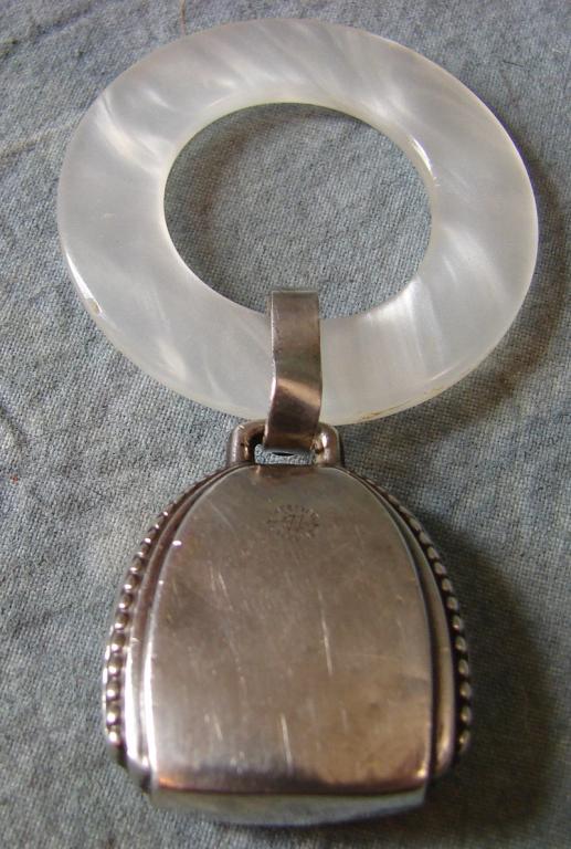 Vintage Sterling Silver Purse Teething Ring: Purse ring of Sterling Silver, marked, with Mother of Pearl ring, measures 3&1/4" long x 1&1/4" poodle and 1&3/4" ring