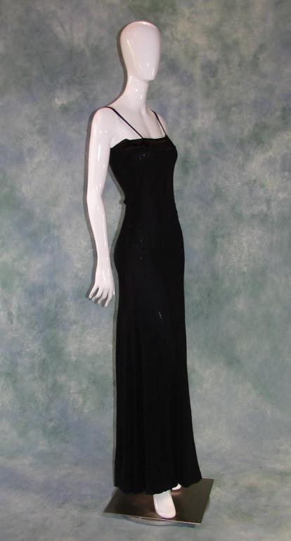1930s Bias Cut Black Crepe Gown: Long waffle like crepe dress or underdress, has a weighted hem in the back, spaghetti straps, 15 metal snaps on the right side, and a silk inserted yoke. Measures 60" L x 30" B x 30" W x 32" H. Fabric