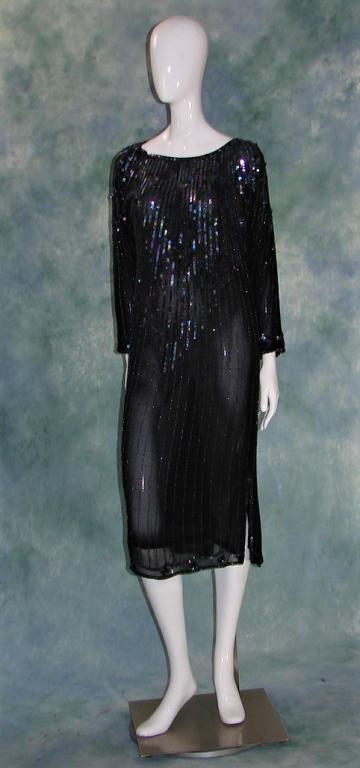 1980s Beaded Chiffon Drop Waist Dress: 1980s does 1920s black textured chiffon gown with multicolor sequins and beads in sequin medallions on bodice, at wrists and hemline, lined in same silk chiffon. 44"L x 38"B 38"W x 40"H