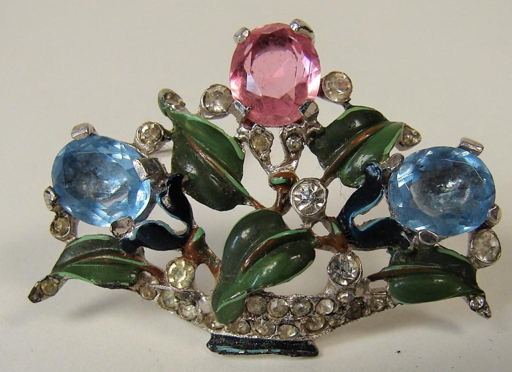 Vintage Trifari Flower Basket Brooch: 1.5" long, 1" tall, has prong set glass, small diamond colored crystals and enamel