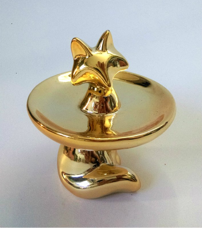A gold glazed ceramic sculpture: Gold glazed sculpture -- Description : Golden fox -- Medium : Gold glazed ceramic -- Dimensions : 9 cm tall --