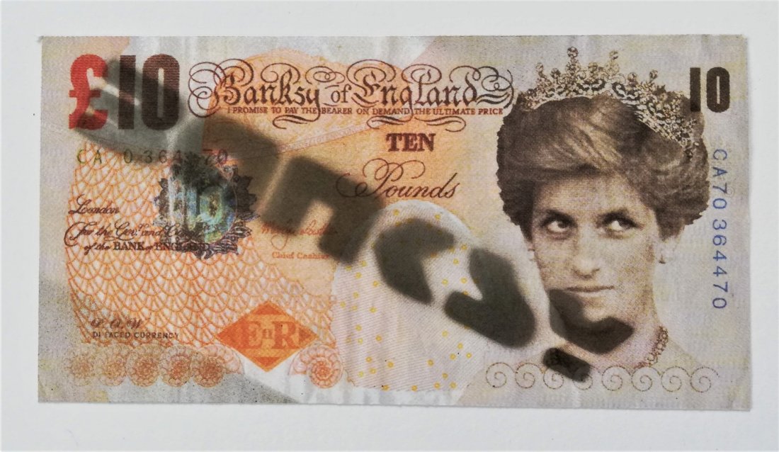 BANKSY (1974 -) DI Faced Tenner: LOT 11162 -- BANKSY (1974 -) -- Description : DI Faced Tenner -- Medium : Print in color with black spray paint -- Dimensions : 8 x 14.5 cm -- Estimate : 20 -30 Euro