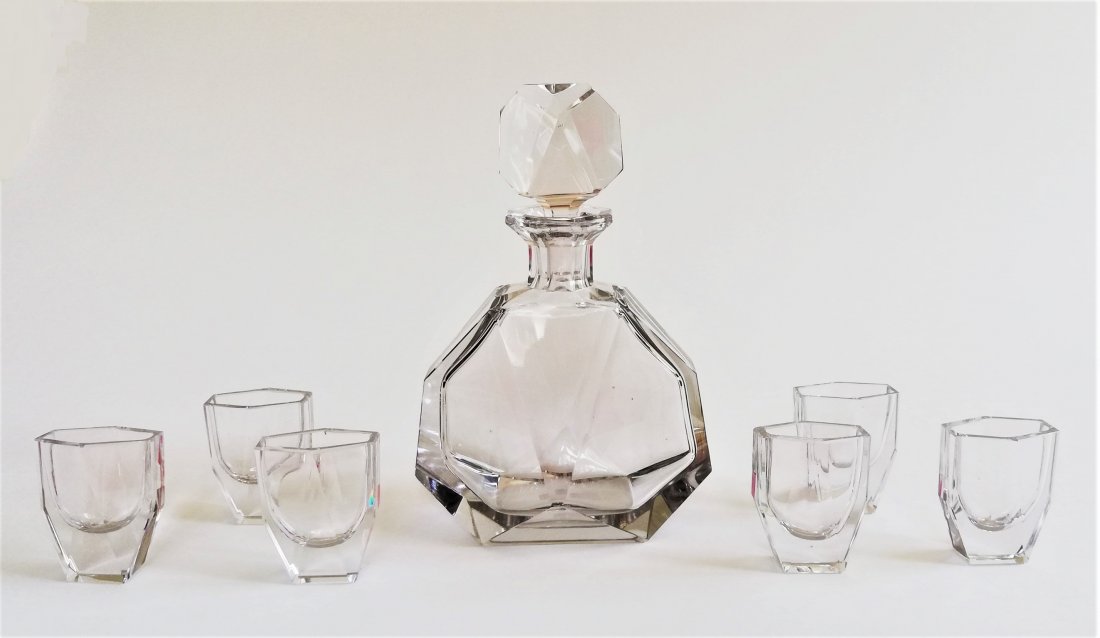 Bohemian 1920 Art Deco decanter set: LOT 14067 -- Bohemian 1920 Art Deco decanter set -- Description : 8 pc decanter set -- Medium : Clear coloured lead glass -- Dimensions : 23 cm tall, glasses 6.5 cm tall -- Estimate : 200 -300 Euro