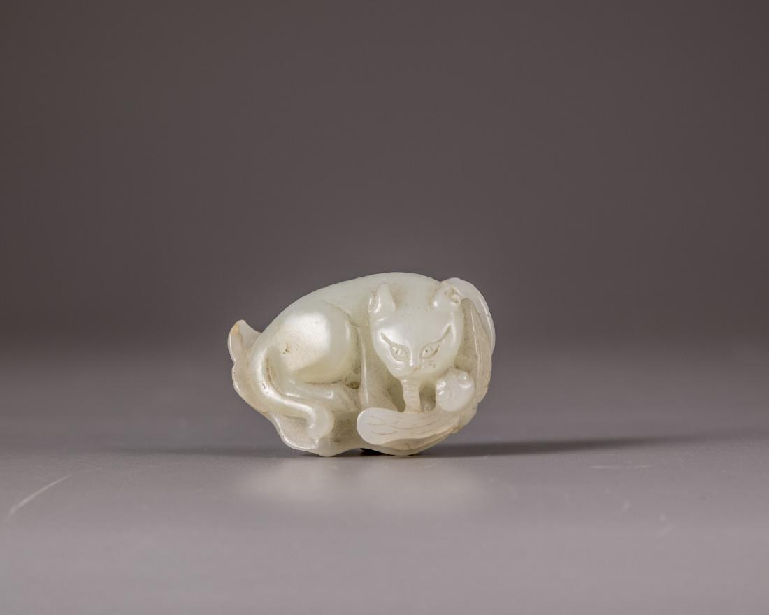 A Chinese pale celadon jade 'cat and dragonfly' carving (1 of 3)
