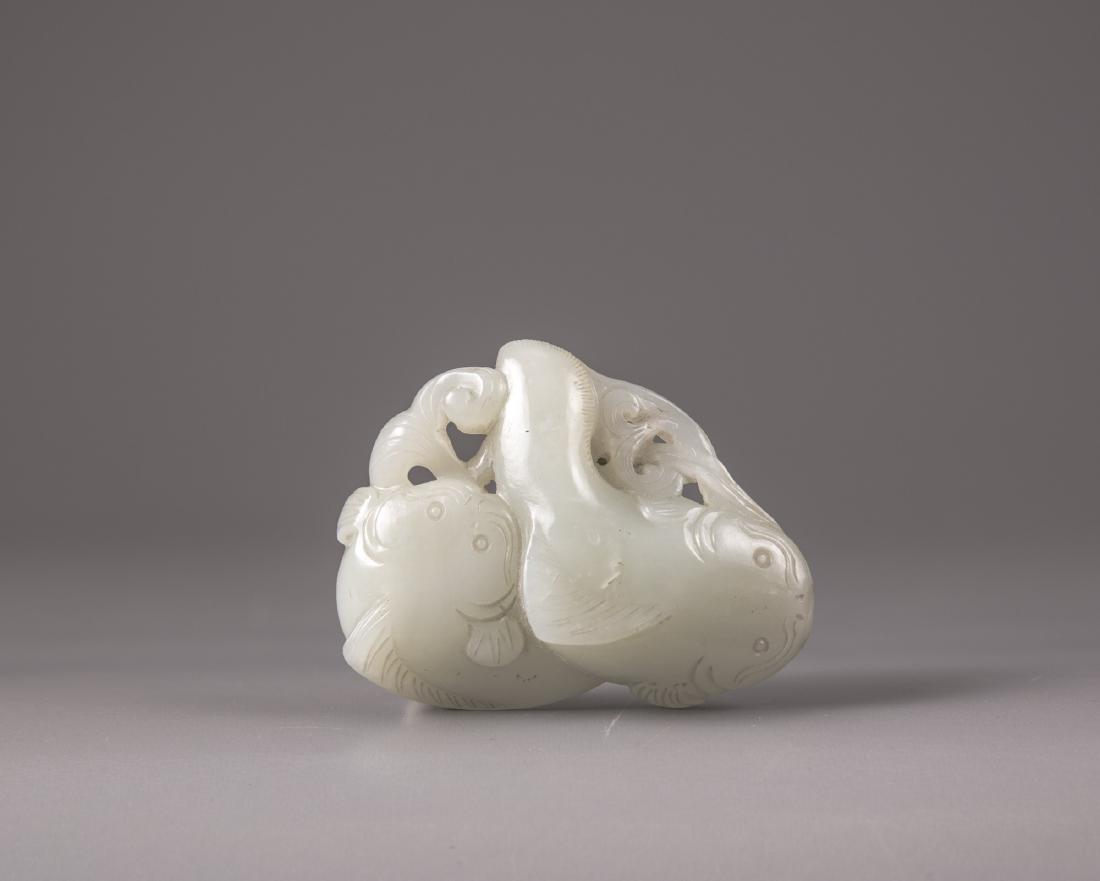 A Chinese pale celadon jade 'twin catfish' carving (1 of 3)
