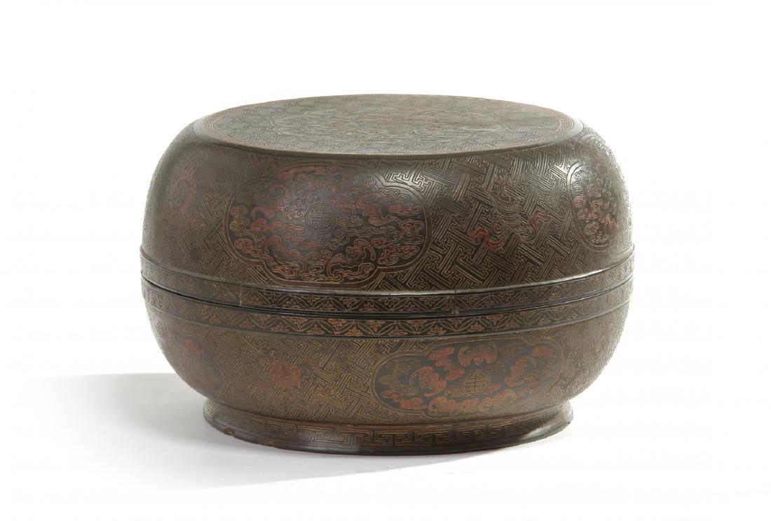 A Chinese Qiangjin and Tianqi lacquer circular box and: The lacquer box is incised with gilt and filled in with a central octafoil panel enclosing a 'shou' character roundel surrounded by five bats, wufu, amongst clouds. All set on a wan-design ground. The