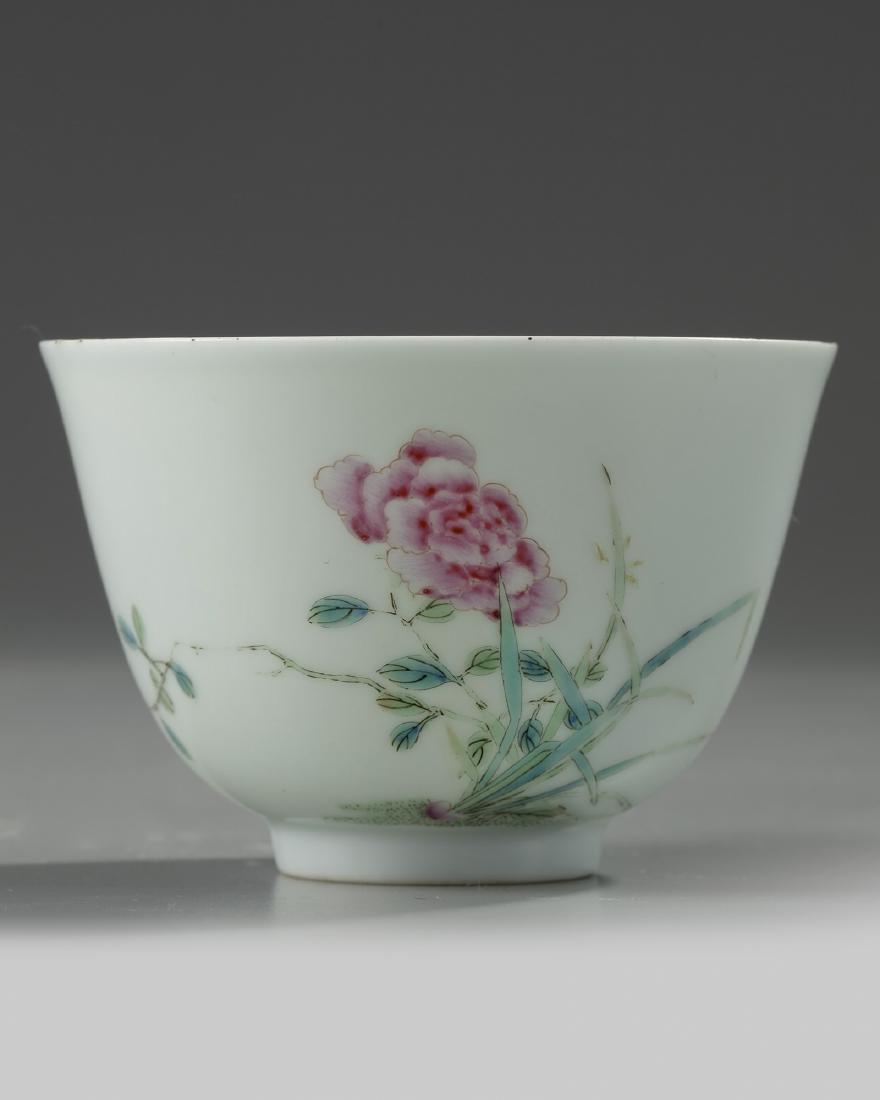 A small Chinese famille rose ‘rose’ cup: The exterior is delicately enamelled with a large rose branch growing amongst grasses, the reverse with small insects in flight. The base with a Yongzheng mark. Condition: A few tiny frits to the rim,