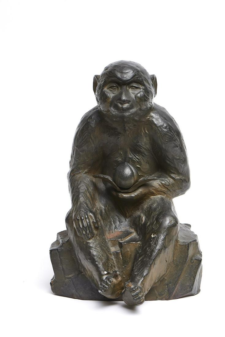 A large Japanese bronze figure of a monkey sitting on a: Large bronze figure of a monkey sitting on a rock with a persimmom in its hand, signed at the bottom: Kansui (Watanabe Kansui, 1929). Origin: Japan Period: 20th century Sizes: 38.00 cm. H x 24.00 cm. 