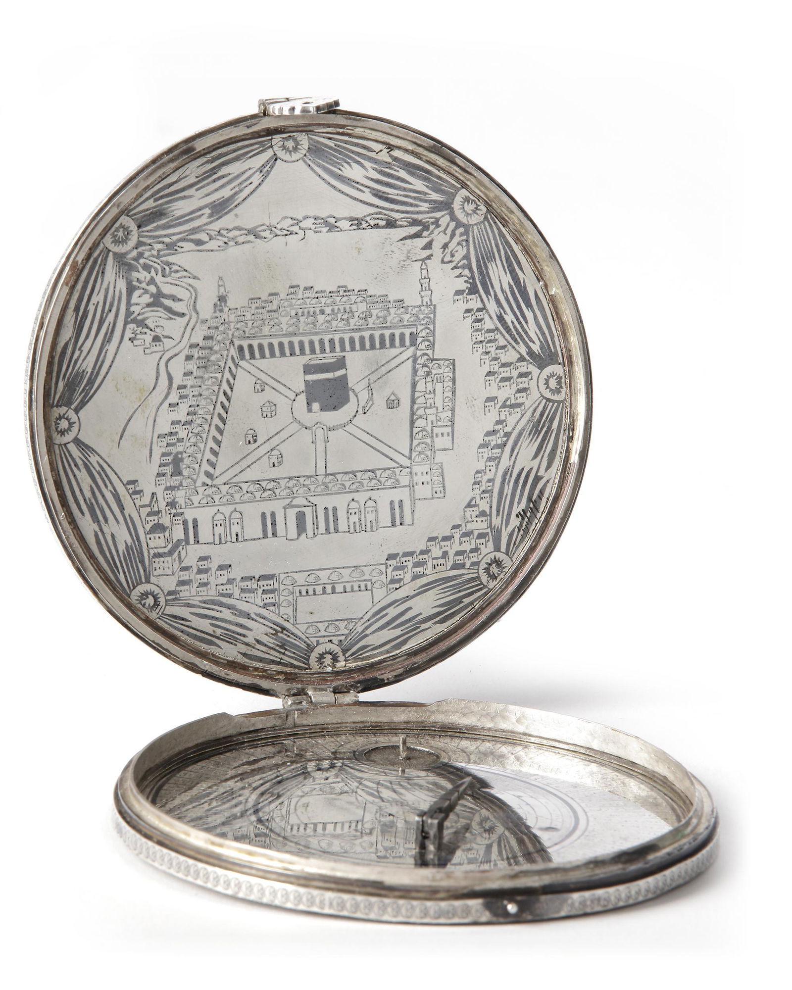 A SILVER PORTABLE FOLDABLE OTTOMAN QIBLA FINDER WITH COMPASS AND DOUBLE SUNDIAL, 19TH CENTURY: Undated. 19th century. Diameter: 8.5 cm. This small portable qibla finder features two sundials, a compass and a circular geographical table in the folk tradition of Islamic science known as a 72-sect