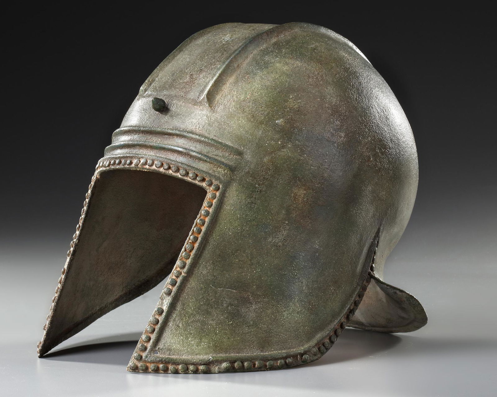 A GREEK BRONZE ILLYRIAN HELMET, CIRCA 6TH-5TH CENTURY B.C. (1 of 12)