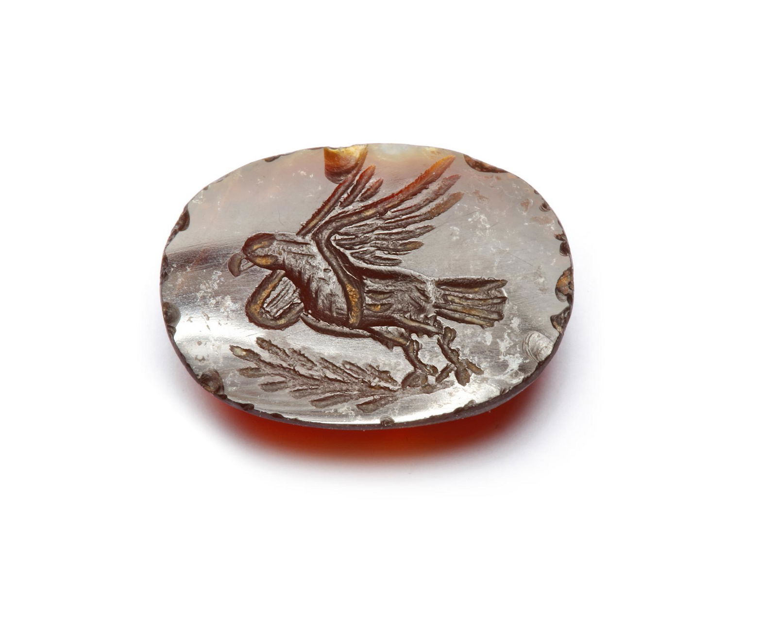 A ROMAN GARNET INTAGLIO OF AN EAGLE, 2ND-3RD CENTURY A.D.: A Roman oval garnet engraved with an eagle on a tree branch. 14 by 7 mm.CONDITION Fine condition.PROVENANCE Previously in British antique market after 2000s.