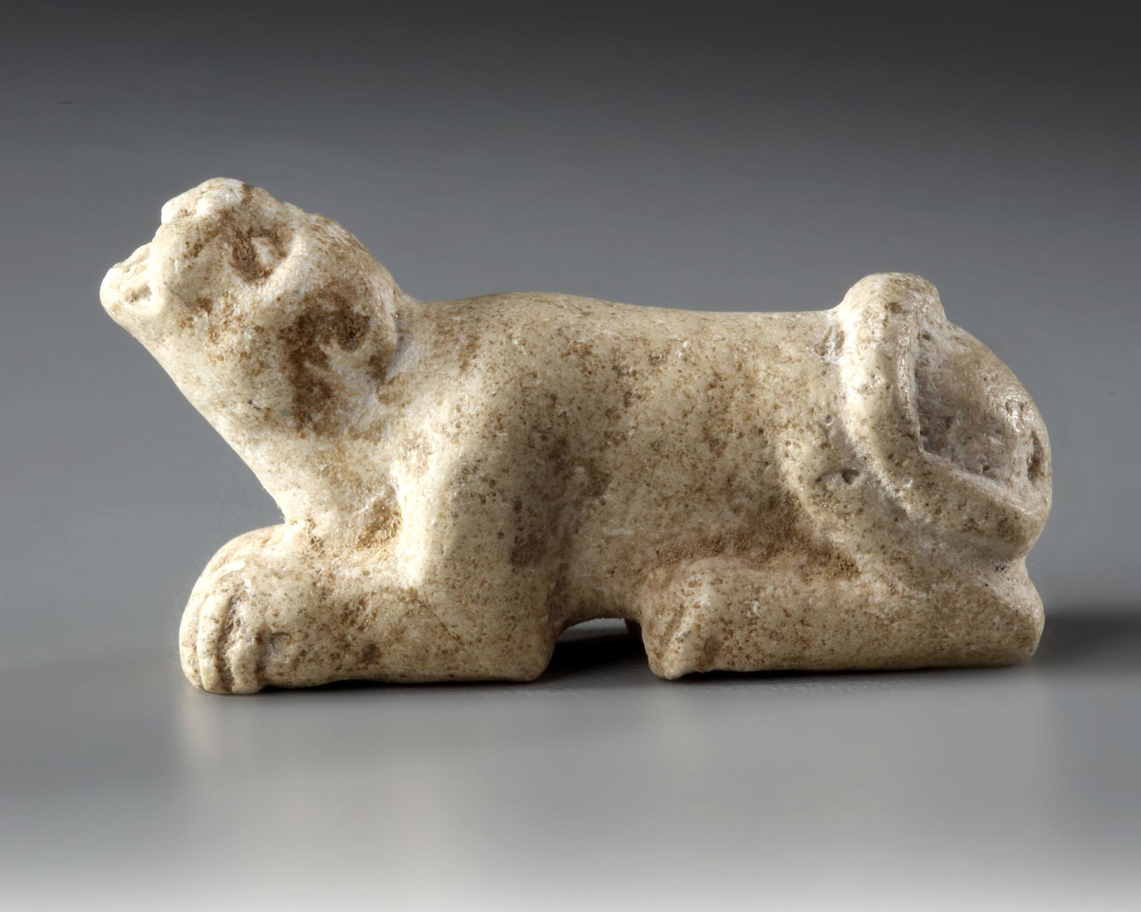 A WESTERN ASIATIC ELAMITE AMULET LIMESTONE WITH LION SEATED, CIRCA 2ND-1ST MILLENNIUM  B.C. (1 of 3)