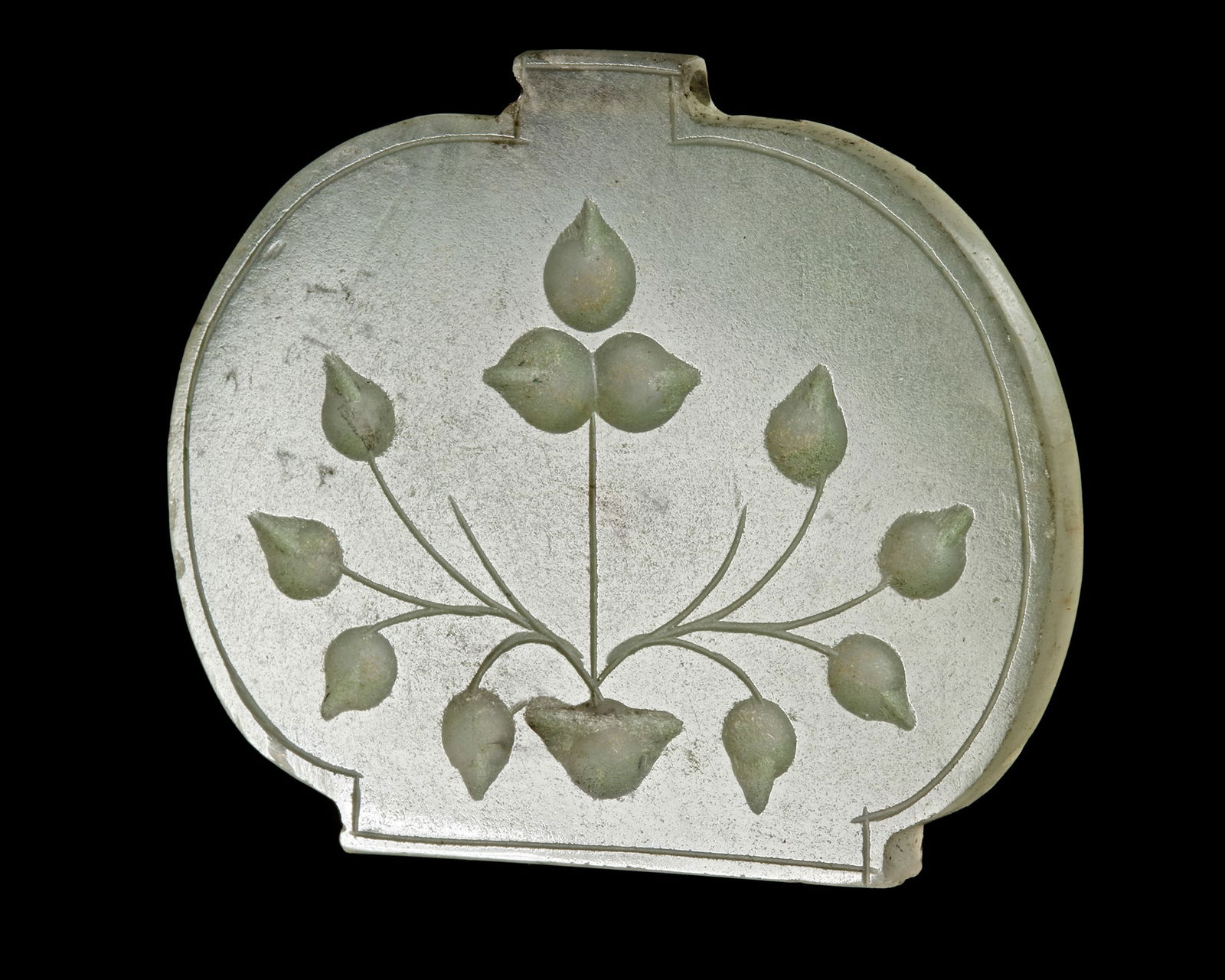 A MUGHAL JADE PENDANT, 18TH CENTURY: A very fine pendant (haldili), carved from a single, translucent piece of light green or ‘mutton fat’ nephrite jade, carved with floral motifs. The colour is more a pale greyish-green and with exc