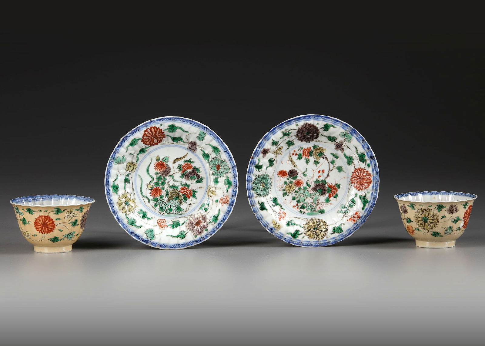 A PAIR OF CAFE AU-LAIT GROUND FAMILLE VERTE CUPS AND SAUCERS, KANGXI PERIOD (1662-1722) (1 of 3)
