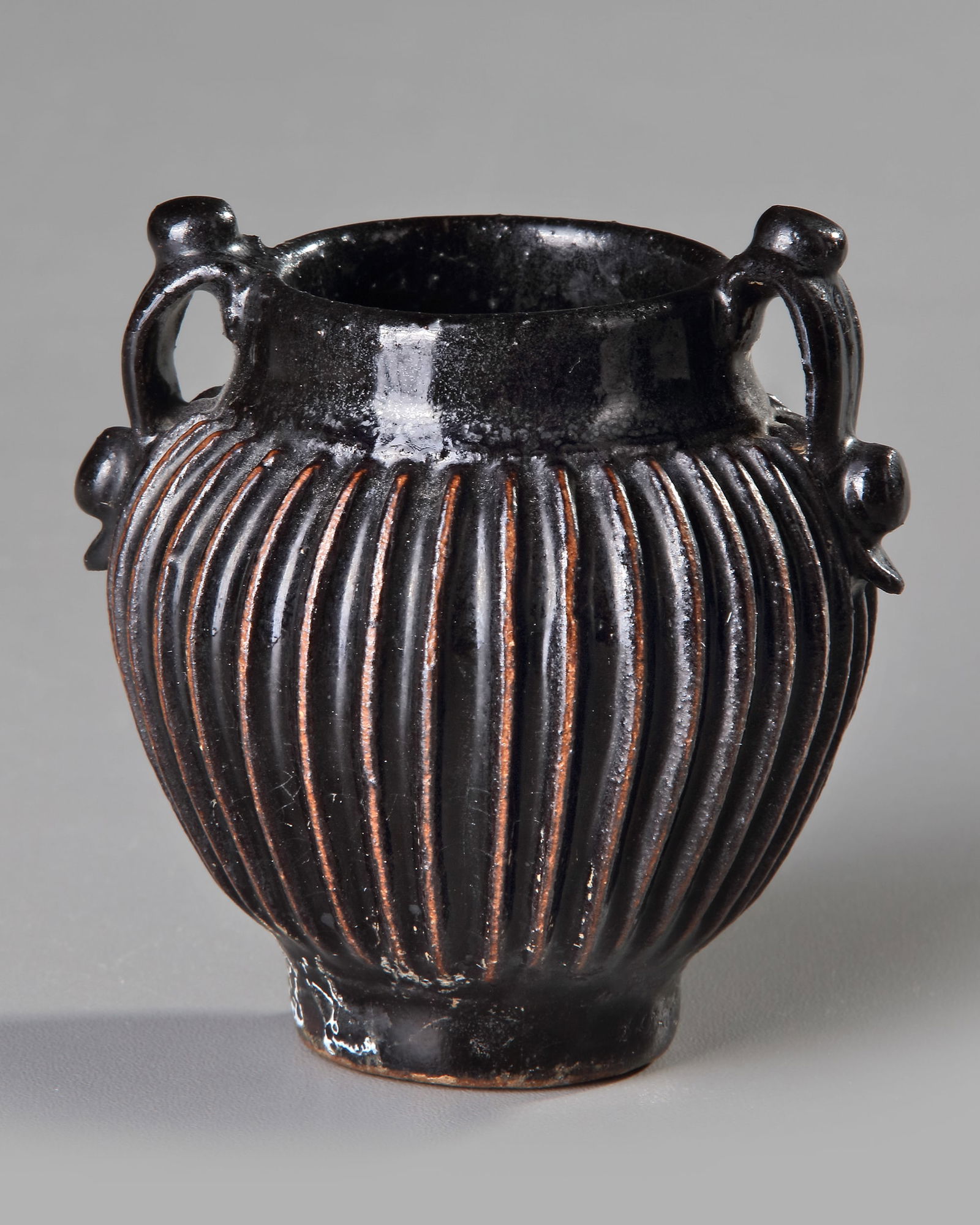 A SMALL CHINESE BLACK-GLAZED RIBBED JAR, SONG DYNASTY (960-1279) (1 of 3)