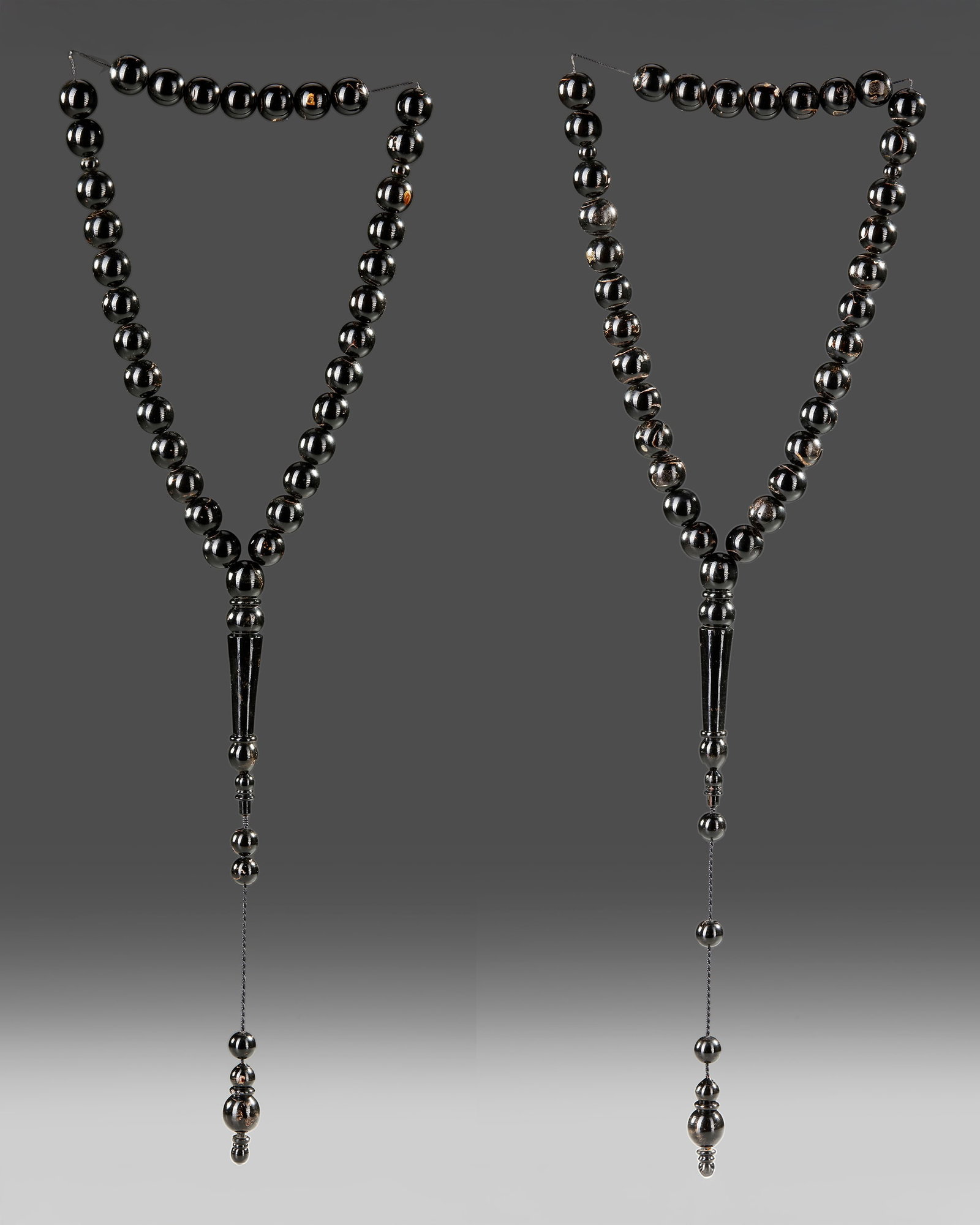 A PAIR OF AMBER PRAYER BEADS, TISBIH, 19TH-20TH CENTURY: Each: 33 beads with 5 extra beads at the top. Strings of prayer beads are usually comprised of 11, 33, or 99 beads, corresponding with the 99 beautiful names of God. (al-asma al-husna) derived from th