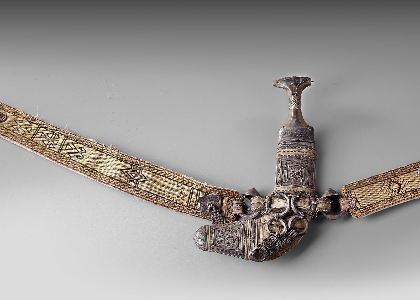 A FOUR-RINGED SILVER JAMBIYA, OMAN OR YEMEN  EARLY 20TH CENTURY (1 of 3)