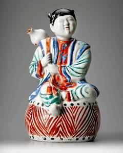 A JAPANESE FIGURE OF A BOY ON DRUM,1670-1690