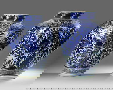 A PAIR OF JAPANESE ARITA BLUE AND WHITE VASES, 17TH CENTURY: These octagonal ovoid vases are richly adorned with underglaze-blue depictions of ho-ho birds among peonies, chrysanthemums, and hydrangeas, set against rockwork within a fenced garden scene. A